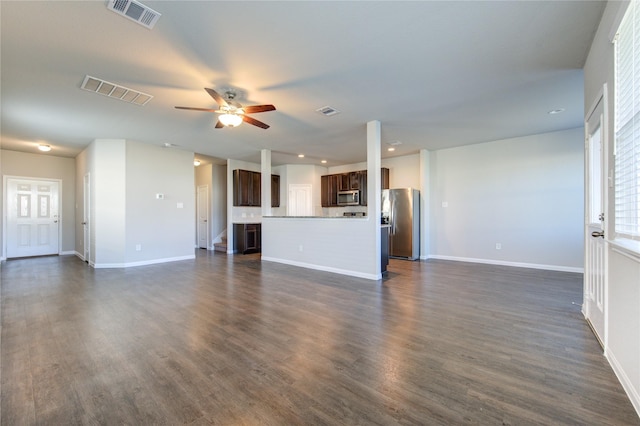 unfurnished living room with ceiling fan and dark wood-type flooring