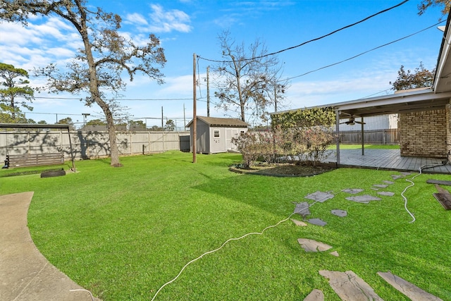 view of yard with a shed and a deck