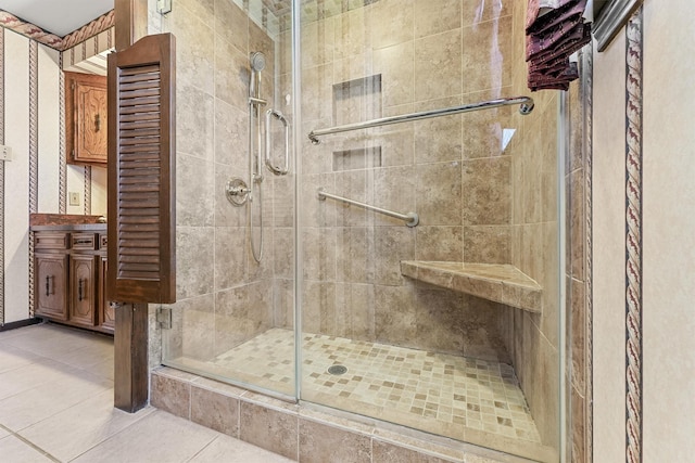 bathroom with tile patterned floors and a shower with shower door