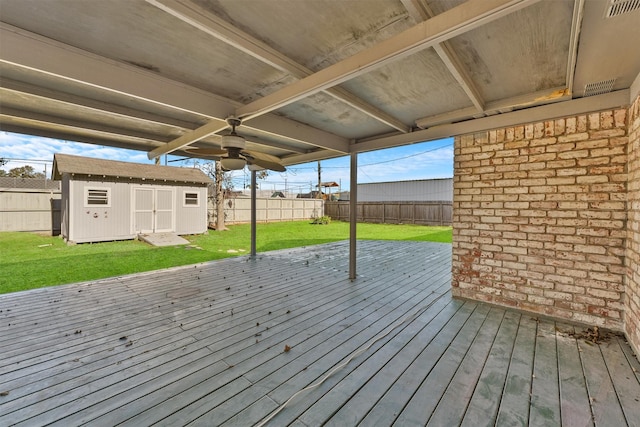 deck with a storage unit and a yard