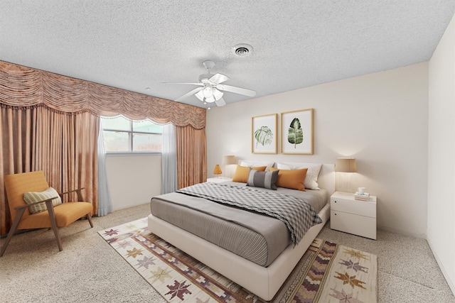 bedroom featuring ceiling fan, carpet floors, and a textured ceiling