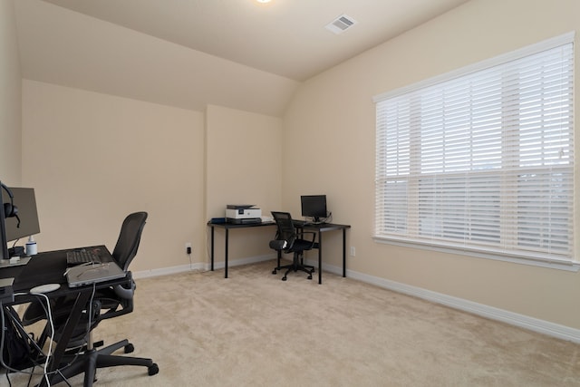 carpeted office with lofted ceiling