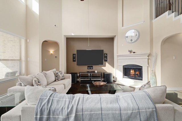 living room featuring a wealth of natural light and a high ceiling