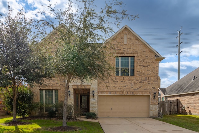 view of front of property with a garage and a front lawn