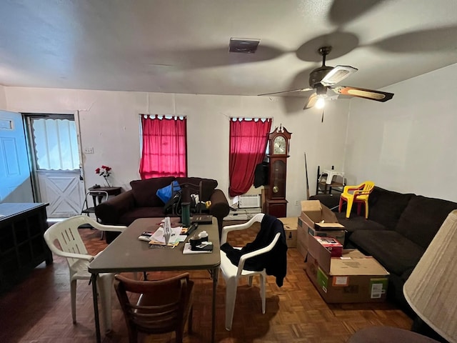 dining room with ceiling fan and dark parquet floors