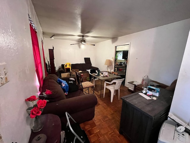 living room featuring dark parquet floors and ceiling fan