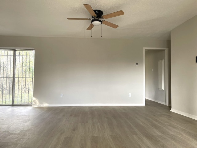 spare room featuring a textured ceiling, dark hardwood / wood-style floors, and ceiling fan