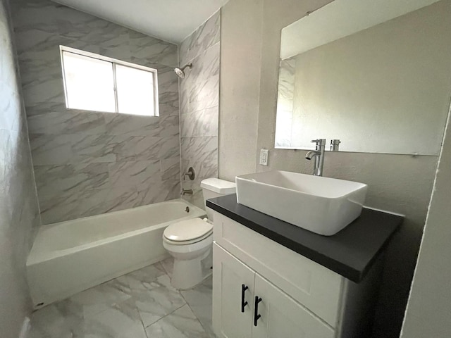 full bathroom featuring vanity, toilet, and tiled shower / bath