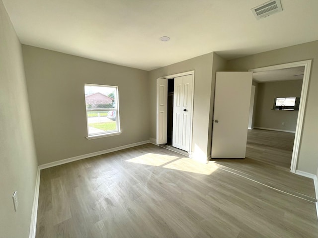 unfurnished bedroom featuring a closet and light hardwood / wood-style flooring