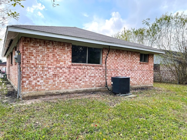 view of property exterior with a lawn and cooling unit