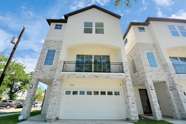 view of front of house featuring a garage and a balcony