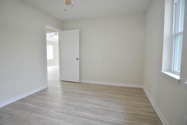 empty room featuring a healthy amount of sunlight and light wood-type flooring