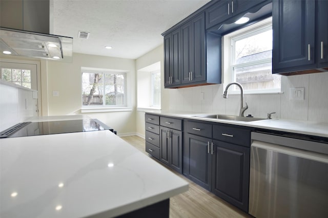 kitchen with a textured ceiling, sink, exhaust hood, dishwasher, and light hardwood / wood-style floors