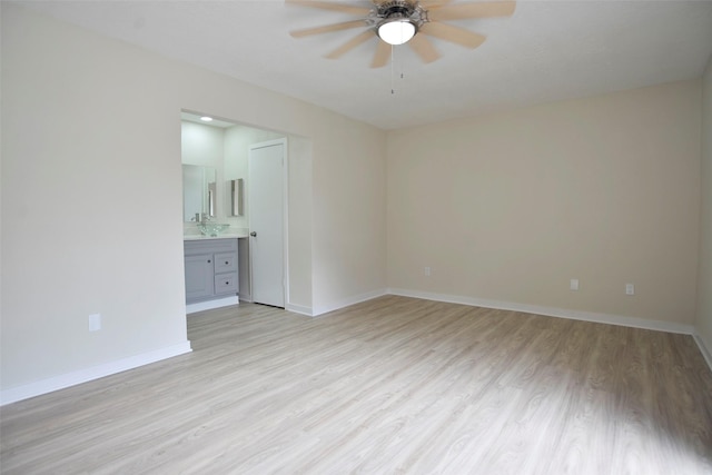 spare room with ceiling fan and light hardwood / wood-style flooring