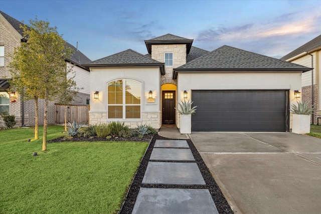 view of front facade featuring a lawn and a garage