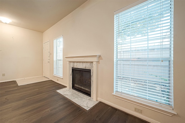 unfurnished living room with a fireplace and hardwood / wood-style floors