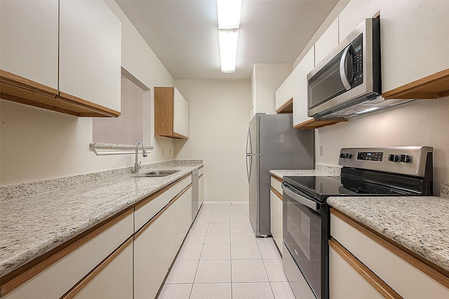 kitchen featuring white cabinetry, sink, and appliances with stainless steel finishes