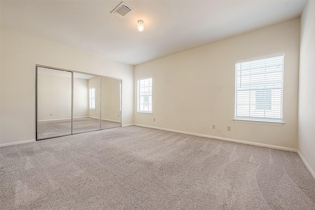 unfurnished bedroom with carpet floors and a closet