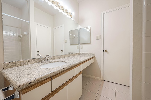 bathroom with tile patterned floors, vanity, and walk in shower