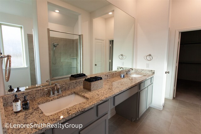 bathroom featuring tile patterned floors, vanity, and an enclosed shower