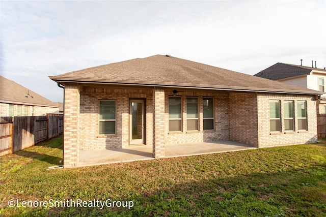 rear view of house with a lawn and a patio area