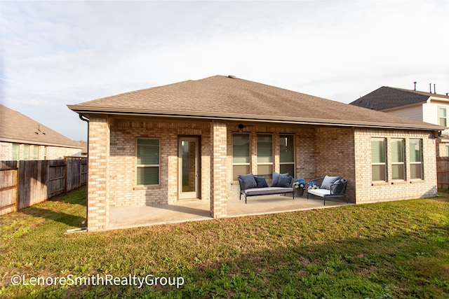 rear view of house featuring a lawn, a patio area, and outdoor lounge area