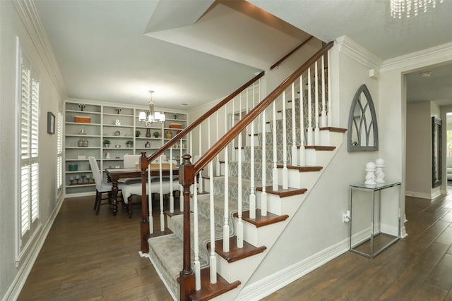 stairs featuring crown molding, a notable chandelier, hardwood / wood-style floors, and a wealth of natural light