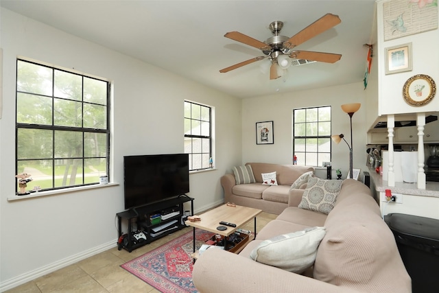 tiled living room with ceiling fan and plenty of natural light