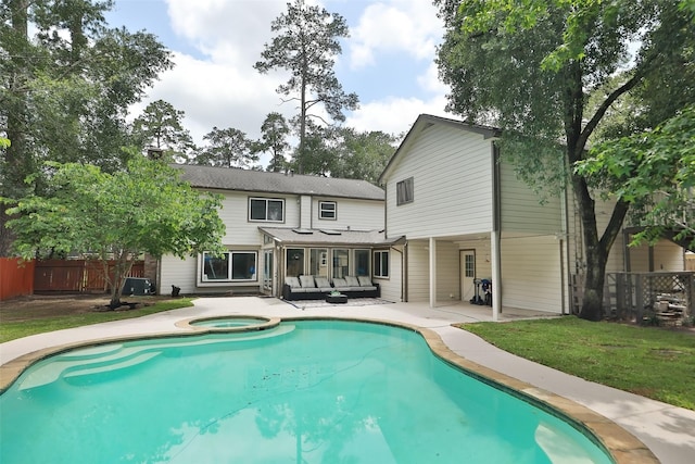 rear view of property featuring a swimming pool with hot tub, a lawn, outdoor lounge area, a patio, and central air condition unit