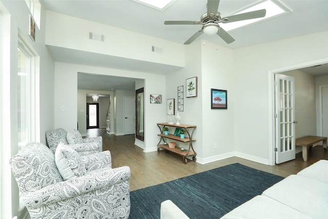 living room with ceiling fan and dark hardwood / wood-style floors