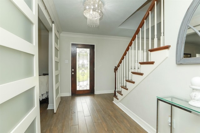 foyer entrance with crown molding, dark hardwood / wood-style flooring, and a notable chandelier