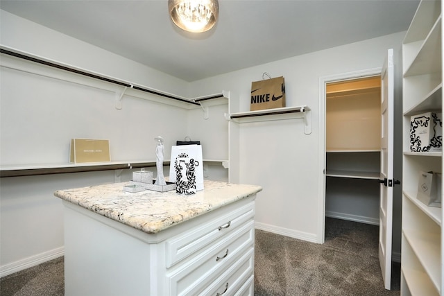 spacious closet featuring dark colored carpet