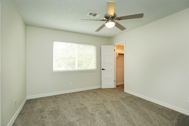 unfurnished room with ceiling fan and carpet floors