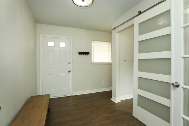 entryway featuring a barn door and dark hardwood / wood-style floors