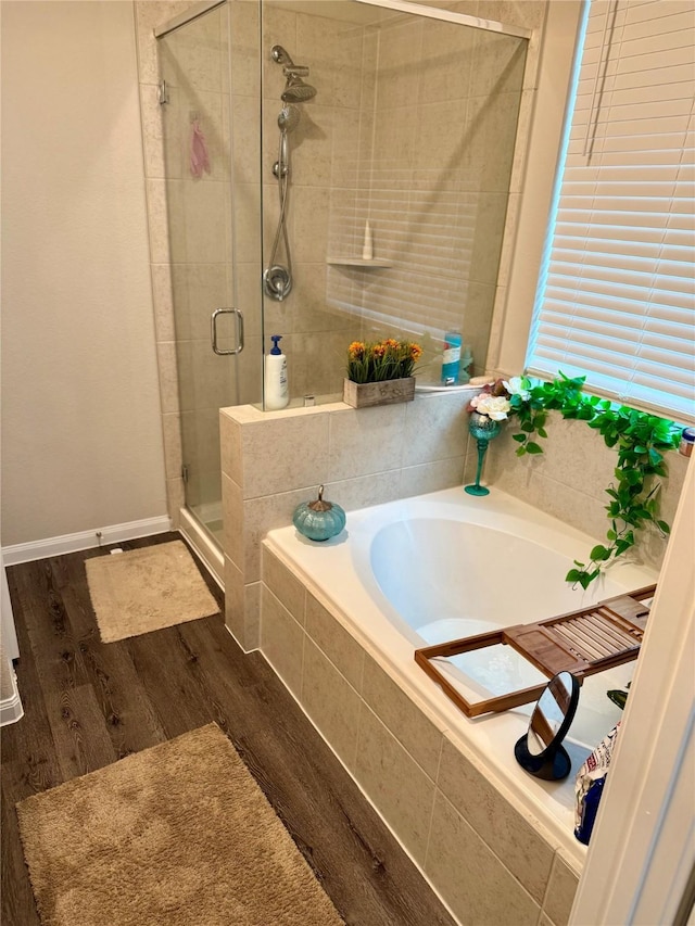 bathroom with separate shower and tub and hardwood / wood-style flooring