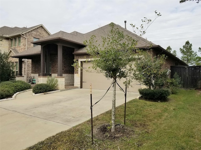 view of front facade featuring covered porch, a garage, and a front lawn