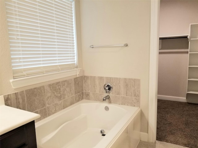 bathroom with vanity and a tub