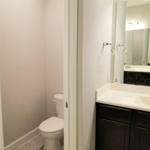 bathroom featuring tile patterned floors, vanity, and toilet