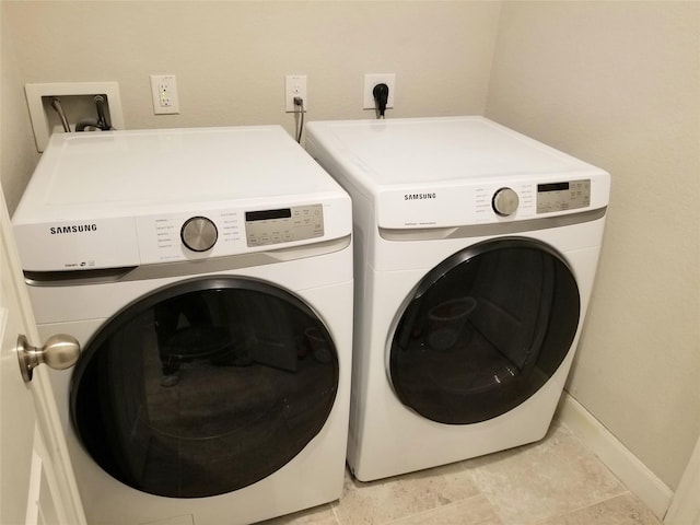 washroom with washing machine and dryer