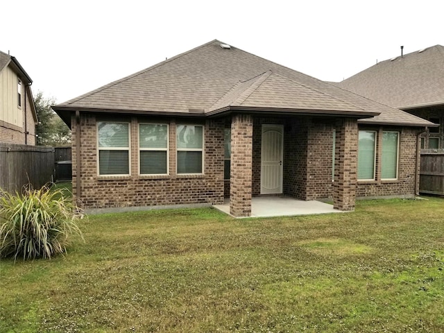 back of property featuring a yard and a patio