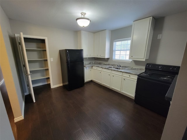 kitchen with sink, dark hardwood / wood-style flooring, white cabinetry, and black appliances