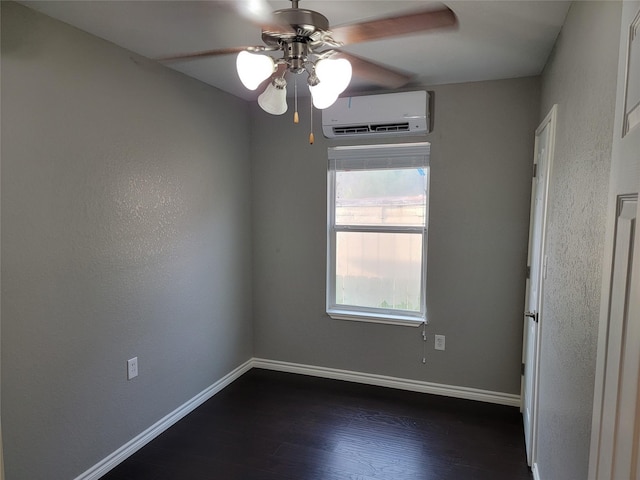 unfurnished room with ceiling fan, dark hardwood / wood-style flooring, and a wall unit AC