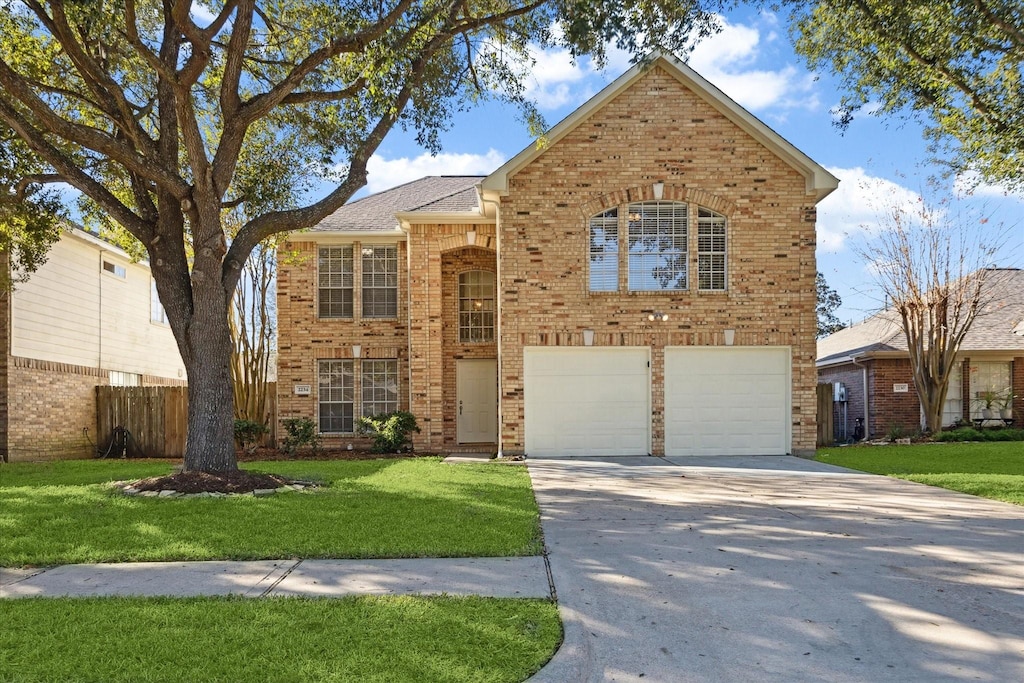 front facade featuring a front yard and a garage