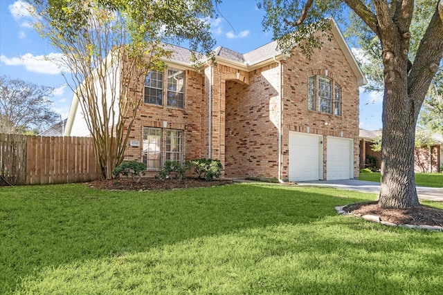 view of property with a front yard and a garage