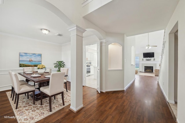 dining room featuring ceiling fan, dark wood-type flooring, and ornamental molding