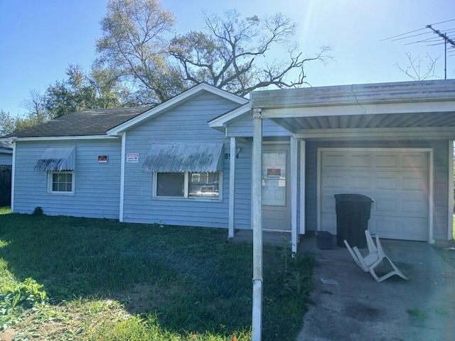 view of side of property with a carport and a garage