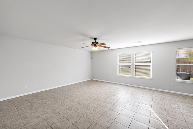 spare room featuring ceiling fan and light tile patterned flooring