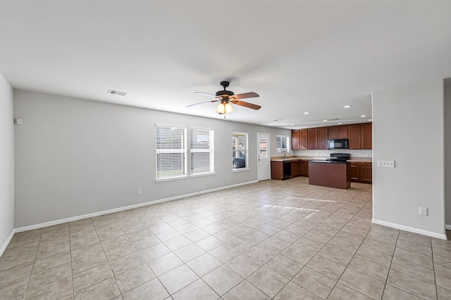 kitchen featuring black appliances, ceiling fan, light tile patterned flooring, and a kitchen island