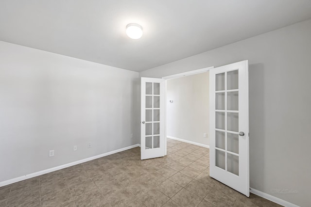 unfurnished room featuring french doors