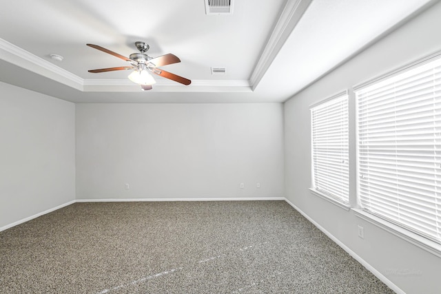 empty room featuring ceiling fan, crown molding, and a tray ceiling